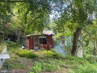 Existing red structure on the wooded property at 90 Hilldale Road