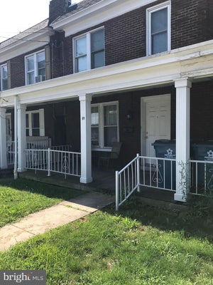 Side exterior and front porch of 60 East Main Street